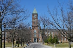 A path leading toward a red-brick building on a college campus