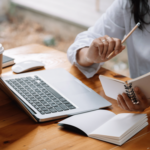 Woman typing on laptop.