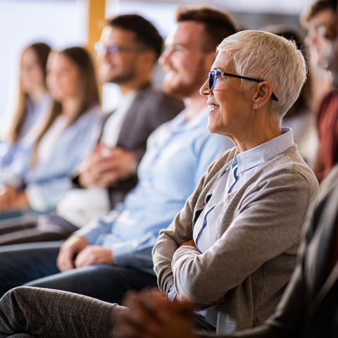 Audience with gray haired woman in the foreground.